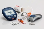 Contour TS blood glucose meter, insulin syringe, lancing device, and test strips on a white background.